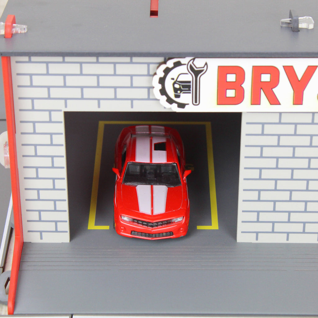 Toy garage with sectional roll-up doors and garage door opener, toy car storage, toy car service station