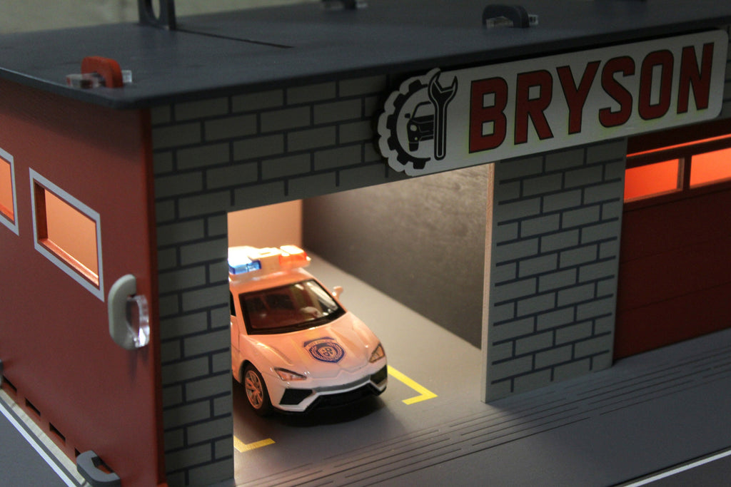 Toy garage with sectional roll-up doors and garage door opener, toy car storage, toy car service station