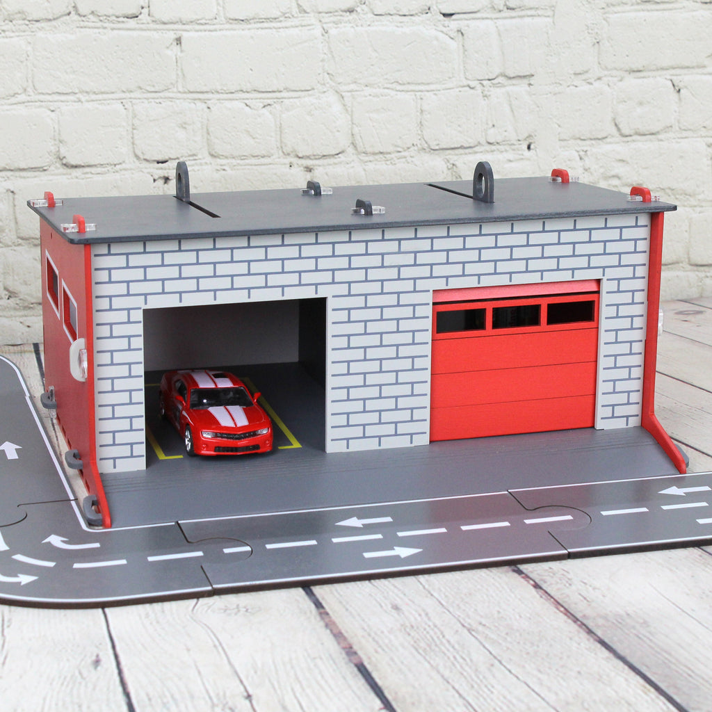 Toy garage with sectional roll-up doors and garage door opener, toy car storage, toy car service station