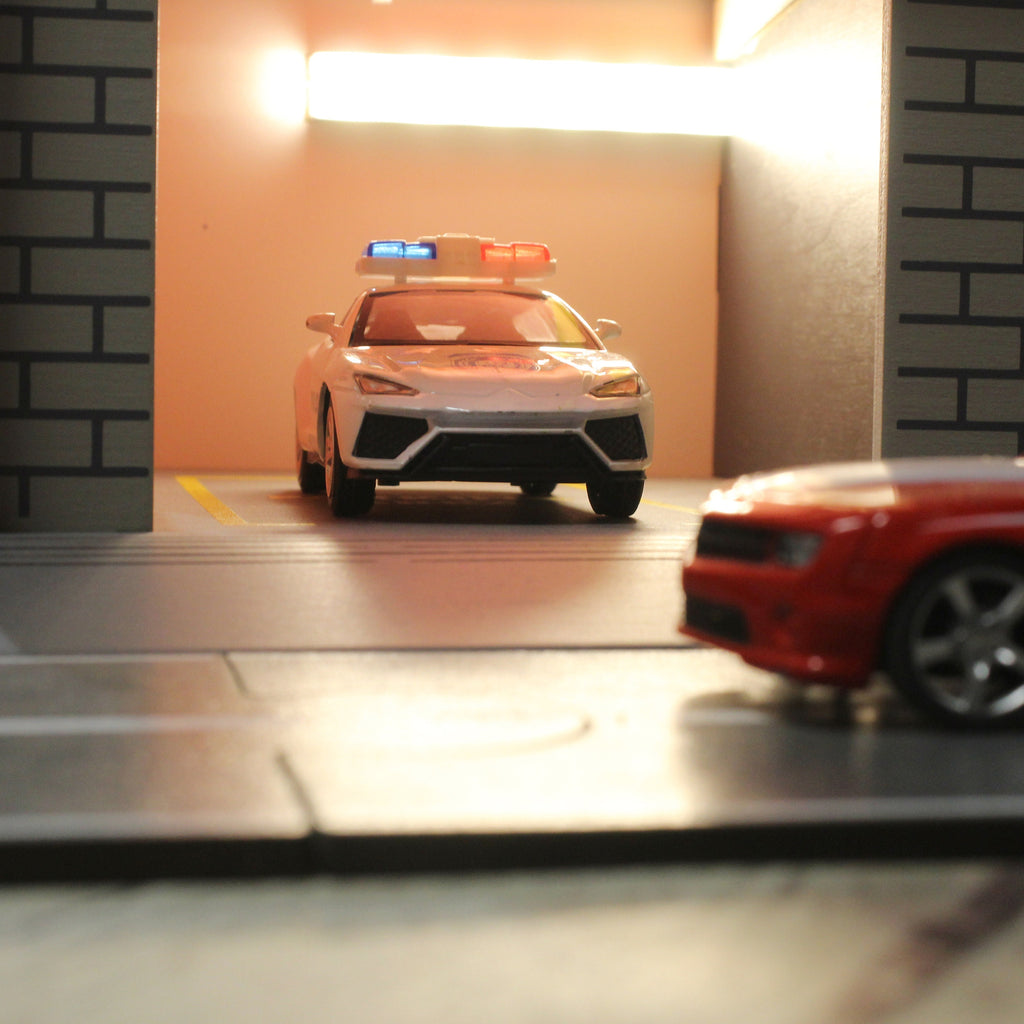 Toy garage with sectional roll-up doors and garage door opener, toy car storage, toy car service station