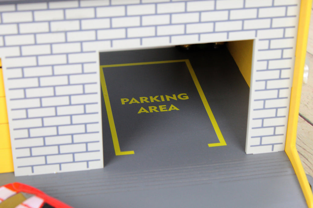 Toy garage with sectional roll-up doors and garage door opener