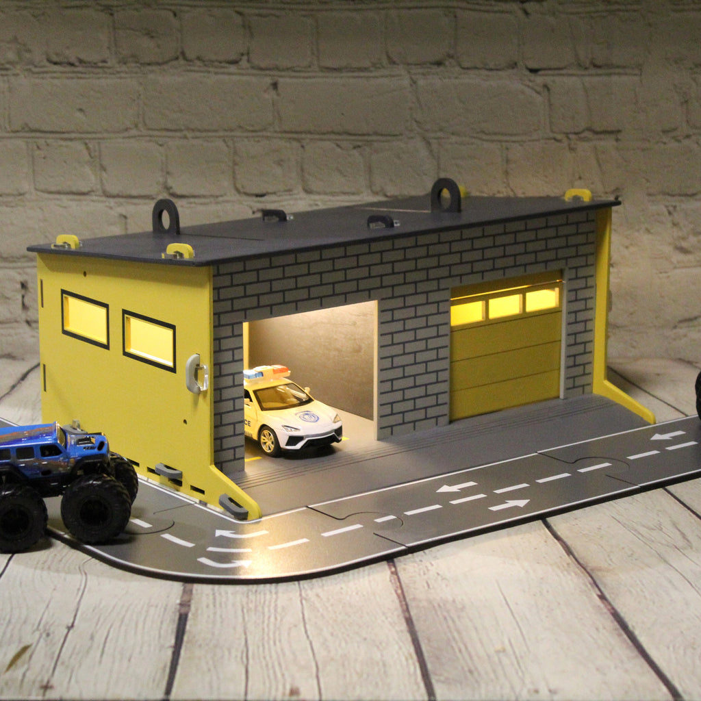 Toy garage with sectional roll-up doors and garage door opener