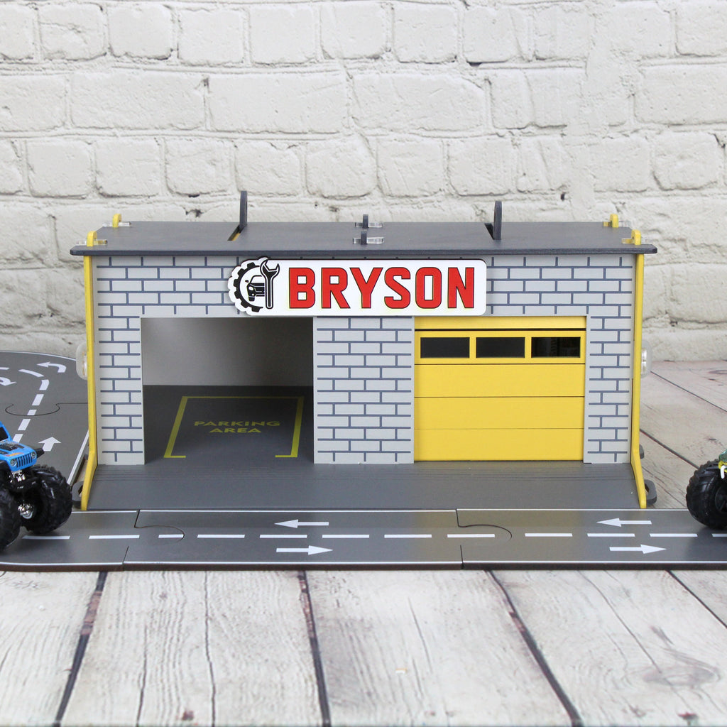 Toy garage with sectional roll-up doors and garage door opener