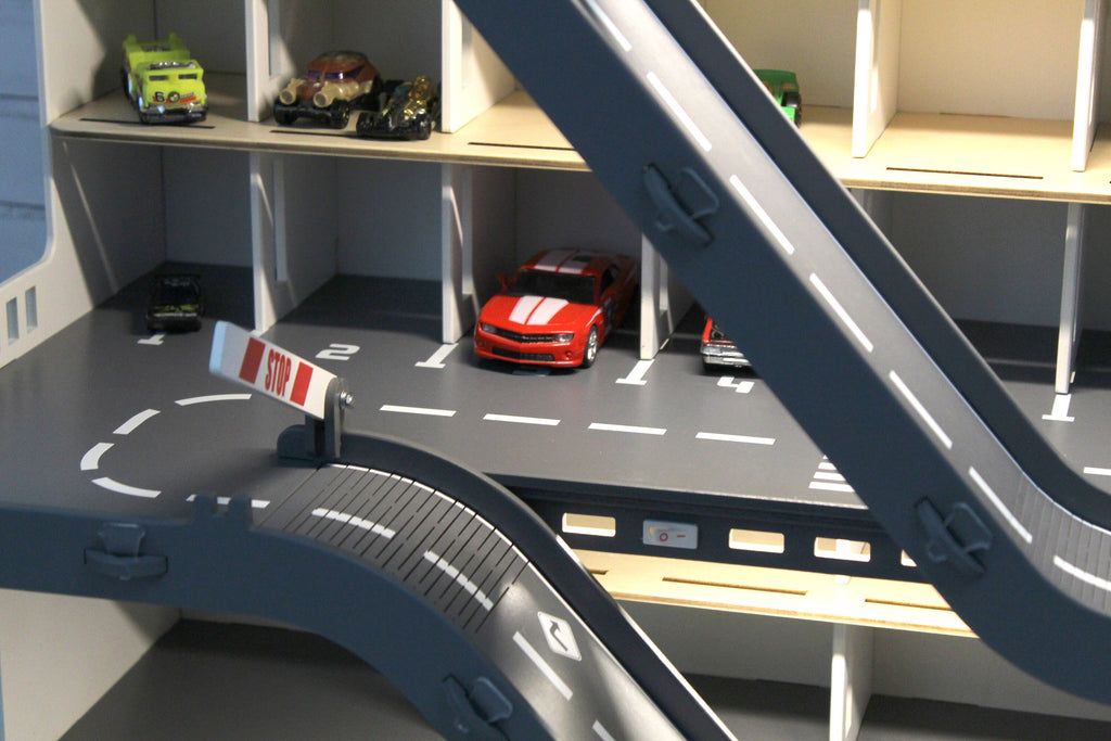 Toy car garage with a toy car wash, doors, gates and mutiple ramps in white