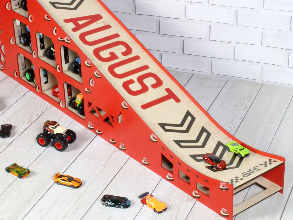 The personalized toy car ramp featuring large letters on the slope, adding a unique touch