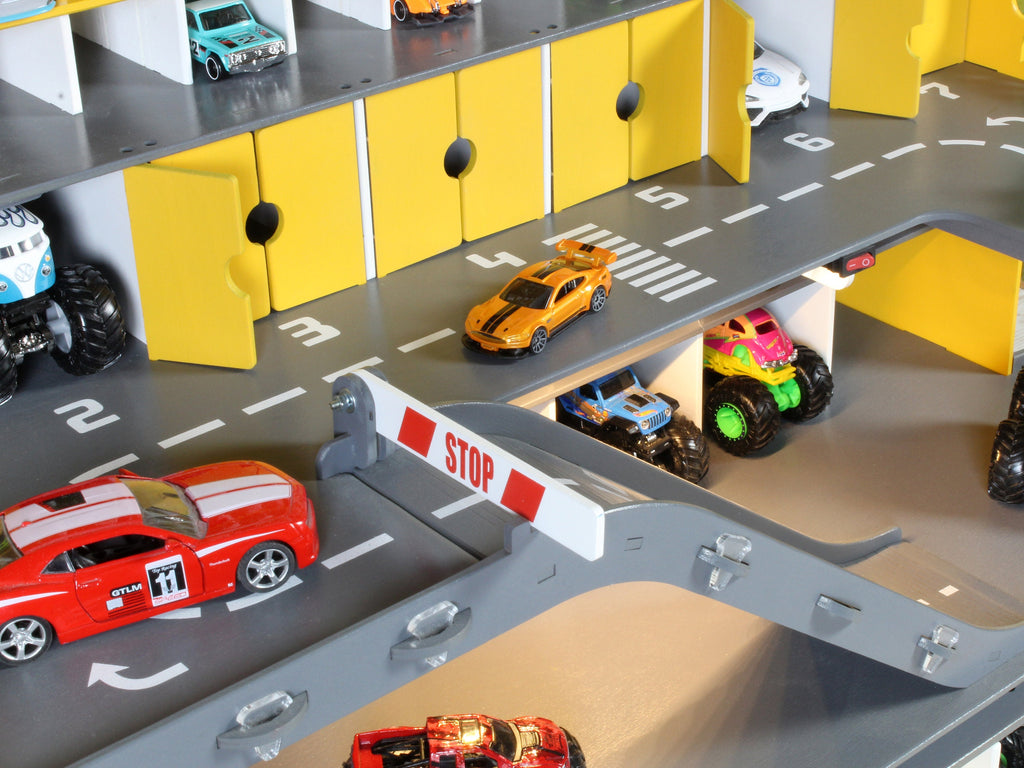 Wooden toy garage for 1:64 scale toy cars, complete with ramps and stop gates
